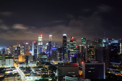 Illuminated cityscape against sky at night