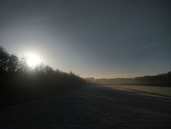 Scenic view of field against clear sky at sunset