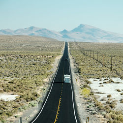 Road amidst sunny landscape