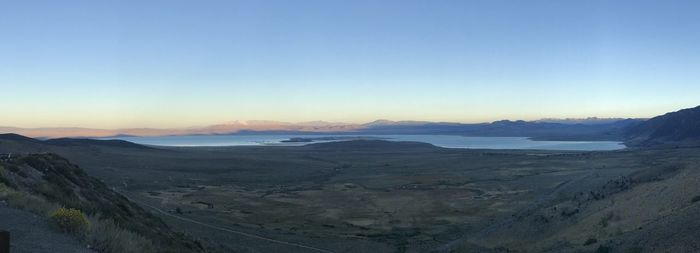 Scenic view of landscape against clear sky during sunset