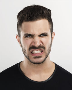 Portrait of young man against white background