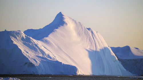 Panoramic view of frozen lake against clear sky