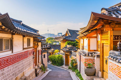 Alley amidst buildings in town against sky