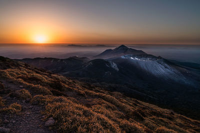 Scenic view of mountain range against clear sky during sunrise