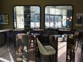 Empty chairs and tables in restaurant