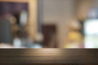 Close-up of woman on table by window