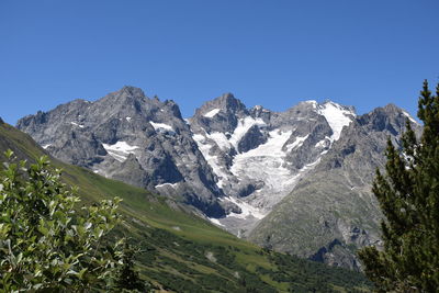 Scenic view of mountains against clear blue sky