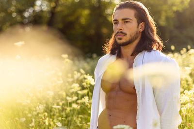 Thoughtful man standing in park