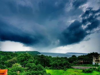 Scenic view of landscape against storm clouds