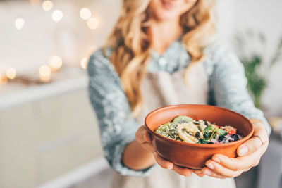 Midsection of woman having food