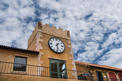 Low angle view of clock tower against sky