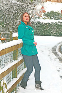 Portrait of woman standing in snow