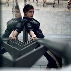 Portrait of woman leaning on railing