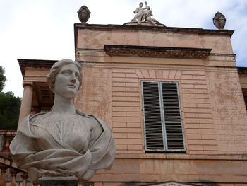 Low angle view of statue against building