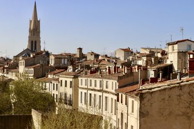 Buildings in city against clear sky