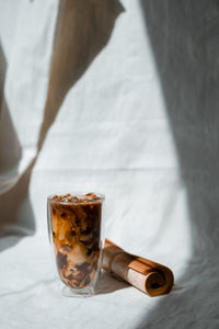 Close-up glass of iced coffee with milk on the table