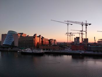 Construction in the city at sunrise and the liffey river