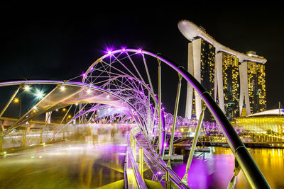 Illuminated ferris wheel at night