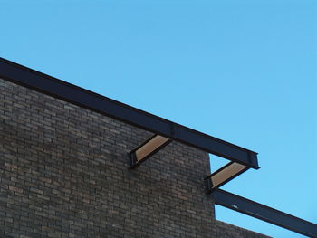 Low angle view of house against clear blue sky
