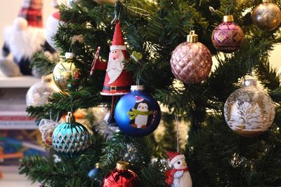 Close-up of christmas decorations hanging on tree