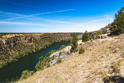 Scenic view of river against blue sky