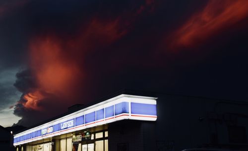 Low angle view of illuminated building against sky at night