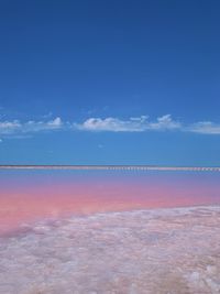 Scenic view of lake against blue sky