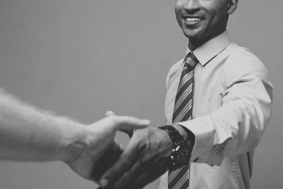 Midsection of businessman shaking hand