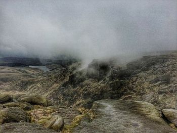 Scenic view of landscape against cloudy sky