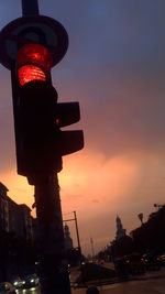 Low angle view of illuminated city at sunset