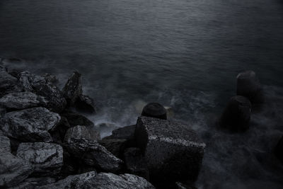 High angle view of rocks on sea shore