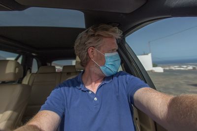 Midsection of man sitting in car