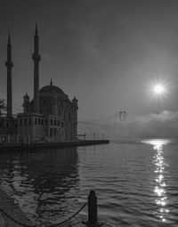 View of buildings at waterfront against sky and fog