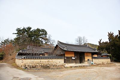 House by building against clear sky