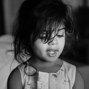 Close-up of cute girl with messy hair at home