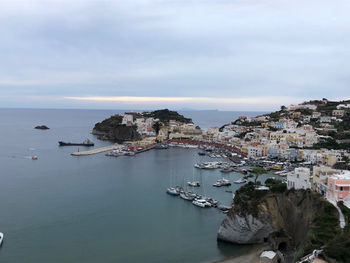 High angle view of townscape by sea against sky