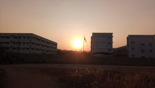 Silhouette buildings against sky during sunset