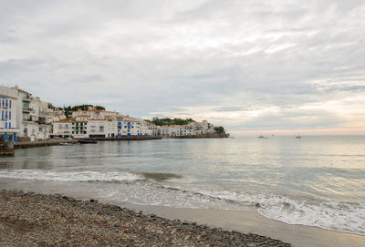 View of beach against cloudy sky