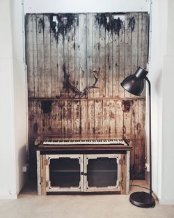 Floor lamp against wooden wall