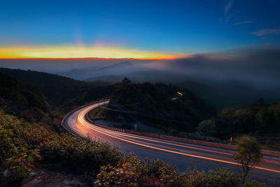 High angle view of light trails on road at sunset