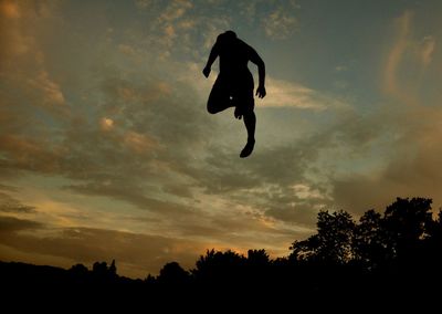 Low angle view of silhouette person against sky during sunset