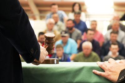 Close-up of judge with people in courtroom