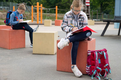 Low angle view of girl sitting on floor