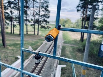 Close-up of padlock on metal grid