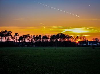 Scenic view of field against sky during sunset