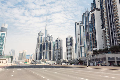 View of skyscrapers against cloudy sky