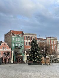 Buildings by street against sky