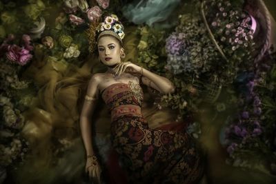 High angle view of woman looking at flowering plants