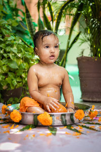 Portrait of cute baby boy sitting on table