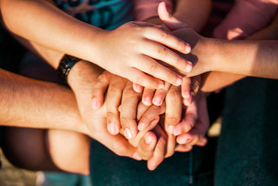 Midsection of couple holding hands